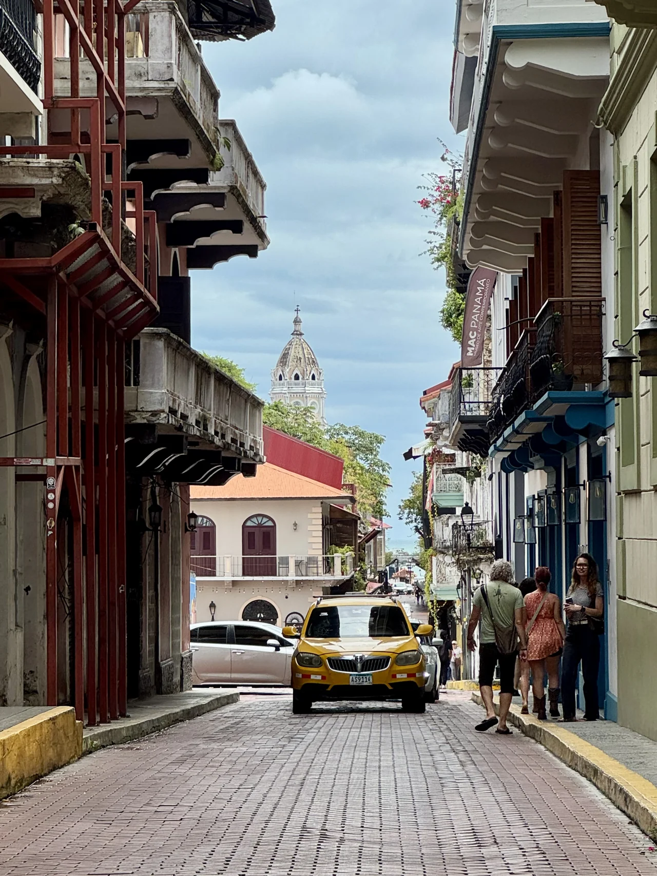 A colorful street and yellow taxi in Casco Viejo, Panama City